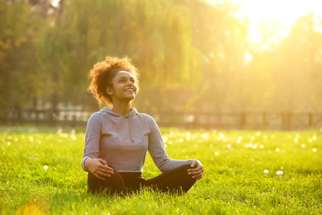 Woman sitting on grass outdoors